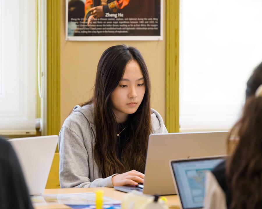 High school student working on her laptop