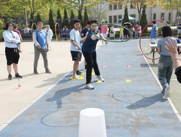 Relay race - a game with hula hoop