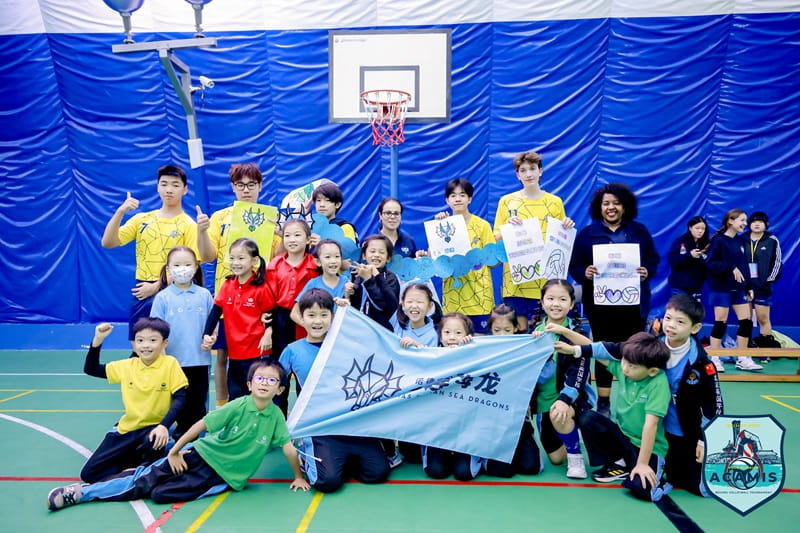 Boys volleyball team with their fans from the host school